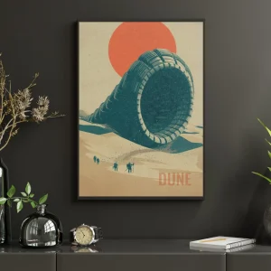 Plakát Dune Shai-Hulud v černém rámu na tmavé stěně – tyrkysový píseční červ před oranžovým sluncem
