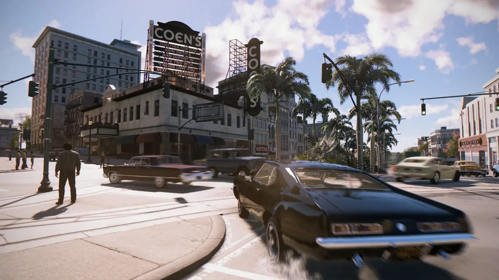 Slunečná křižovatka v New Bordeaux s palmami a černým autem, Mafia III: Definitive Edition