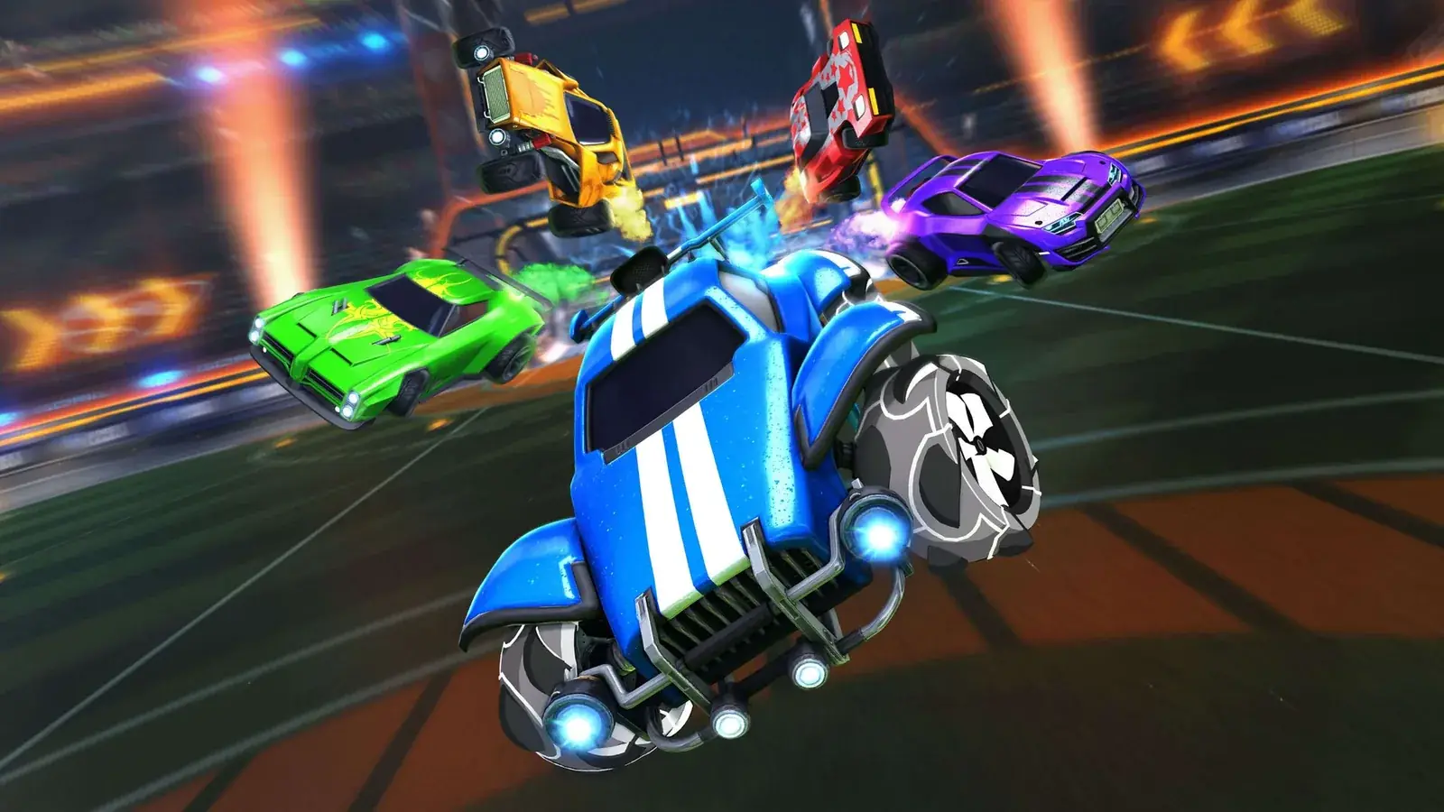 Modré auto Octane v popředí, další auta Rocket League ve vzduchu nad arénou