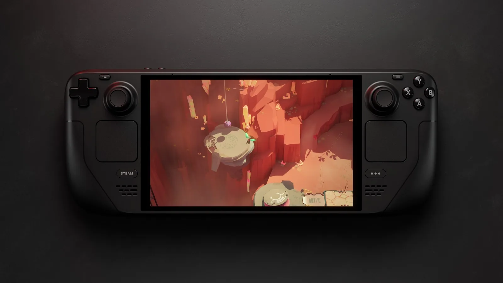Steam Deck OLED zepředu na tmavém pozadí, na displeji hra Cocoon